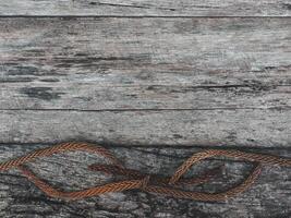 Brown dry pine leaves on old wood for a retro style background. photo