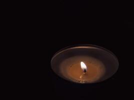 Scented candles in the dark at night for a spa or relaxation background. photo