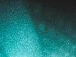 Light reflects blue shadows on a foam board in the dark for a minimalist abstract background. photo