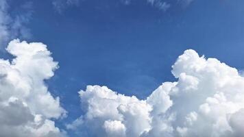 The bright sky view is adorned with clouds that look like cotton with blue sky background. This scene provides a feeling of peace and coolness. photo