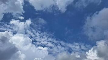 The bright sky view is adorned with clouds that look like cotton with the blue background, creating a refreshing and peaceful atmosphere. photo
