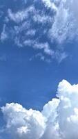 White clouds floating in the bright blue sky. These clouds add a dramatic effect to the scene, creating a captivating contrast between white and blue. photo