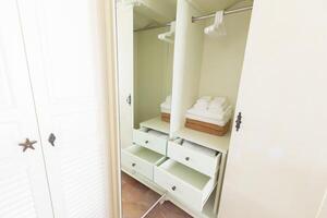 Wardrobe with hanger clothes and accessories in dressing room photo