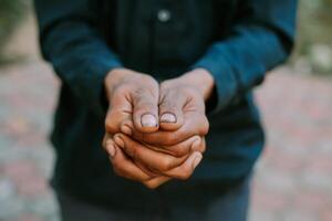 Close-up of cupped hands in a gesture of giving or receiving, conveying simplicity. photo