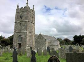 A church with a tower and graveyard in the background photo