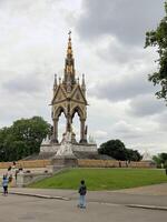 A large statue with a tower in the middle of a park photo