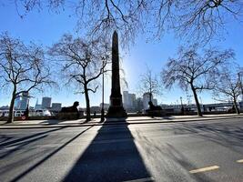 A monument is shown in the middle of a city street photo