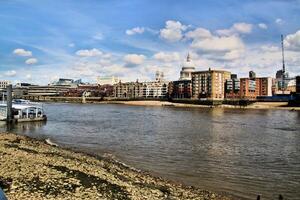 A river with a boat on it and a city in the background photo