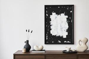 Minimalistic composition of creative living room interior with mock up poster frame and stylish small personal accessories on wooden commode. Copy space. Template. photo