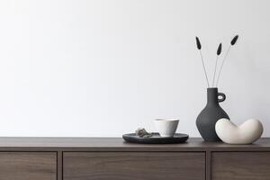Creative minimalistic composition with white wall and stylish small home accessories on wooden commode. Copy space Template photo