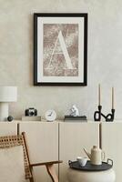 Elegant composition of stylish living room intrerior with mock up poster frame, beige sideboard and minimalistic personal accessories. Copy space. Template. photo