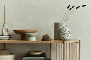 Modern composition of elegant personal accessories on the console in the living room. Vases, candlectick, minerals and trays. Copy space. Template. photo