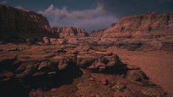 Vast rocky landscape under a dramatic sky with clouds at sunset video