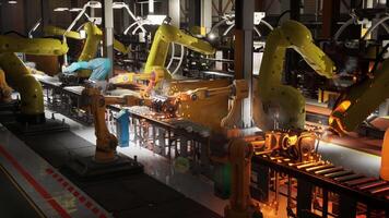 Robotic arms operate on a conveyor belt in an automated factory setting video