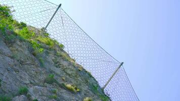 Protective wire mesh on the mountain rocks video
