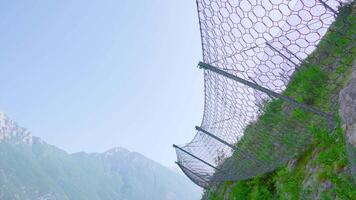 Fence with protective net on the mountain against falls video