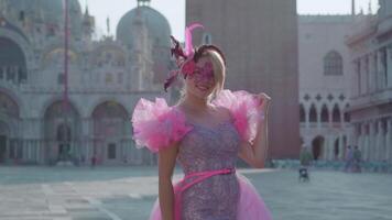 Smiling girl with carnival mask in front of St. Mark's Basilica in Venice video