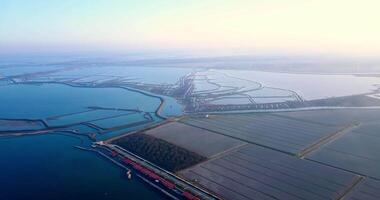 Vegetable fields surrounded by boundless lagoon at sunset video