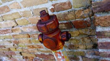 Outdated fire hydrant with red rusty top and greyish support video