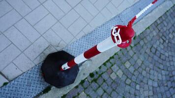 Red and white pole with coloured chain located on drain video