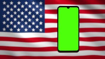 Mobile phone with chromakey screen against American flag video