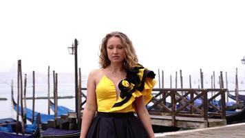 Model in volant carnival dress poses on deserted seafront video