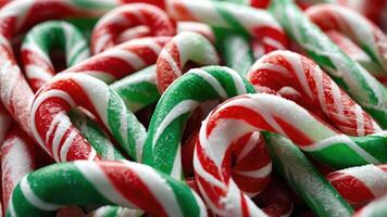 A close-up view of colorful candy canes in red, green, and white, evoking festive cheer. photo