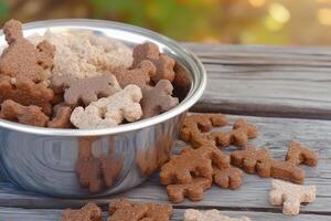 Delightful Assorted Dog Biscuits in a Shiny Metal Bowl photo