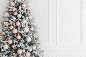 A Classic Christmas Tree with Elegant Ornaments, Against a Pristine White Wall photo