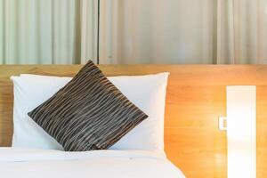 A bed with a pillow and a lamp on it photo