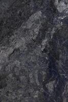 Natural grey stone texture showcasing intricate patterns with subtle veining and earthy tones in natural light photo