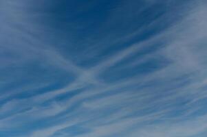 Wispy clouds dance across the azure sky during a tranquil afternoon in nature embrace photo