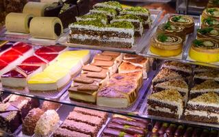 Delectable assortment of traditional pastries displayed in a charming bakery on a sunny afternoon photo