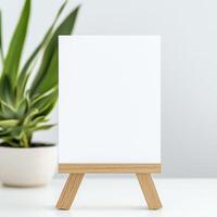A blank A5 landscape card standing upright on a wooden stand against a white background, creating a warm and inviting atmosphere photo