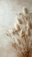 Dry flowers arranged elegantly on a textured surface with subtle colors and patterns photo