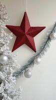 Holiday decorations featuring a red star ornament and festive embellishments on a white background photo