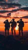 Soldiers salute at sunset while honoring their country with a flag in a mountainous location photo