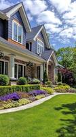 A beautiful suburban home with vibrant gardens and a clear blue sky on a sunny day photo