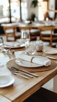 Elegant dining setup with glassware and napkins on wooden table in a cozy restaurant setting photo