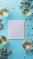 Elegant table setting with champagne glasses and a blank card surrounded by confetti photo