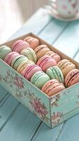 Freshly made colorful macarons arranged neatly in a decorative box on a wooden table photo