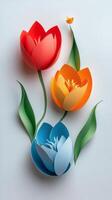 Colorful paper flowers with cut out petals on a light background in an artistic display photo