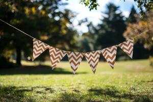 Colorful chevron bunting decorations hanging in a sunny park during a bright afternoon photo