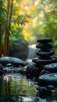 Calm water garden with stacked stones and bamboo in a serene natural setting photo
