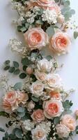Elegant arrangement of pink and white roses with greenery on a light background photo