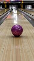 Bowling ball rolls towards pins in a bowling alley during a weekend outing photo