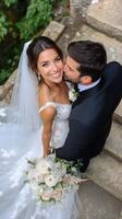A joyful couple celebrates their wedding day with a beautiful bouquet in a charming outdoor setting photo