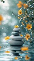 Tranquil stone stack adorned with vibrant yellow flowers beside a serene water surface photo