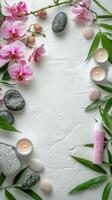 A serene spa setting with flowers, stones, and candles on a calming white surface photo