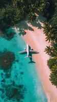 Aerial view of an airplane on a sandy beach surrounded by turquoise water and palm trees photo